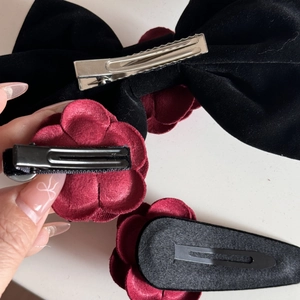 Detail of velvet bow and rose hair clips showing metal duckbill and spring clips