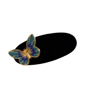 Elegant 3D blue butterfly velvet hair clip with gold lines on a black base
