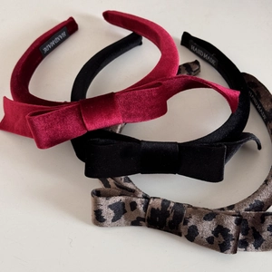 Detailed view of handmade velvet headband set in red, black, and leopard print colors