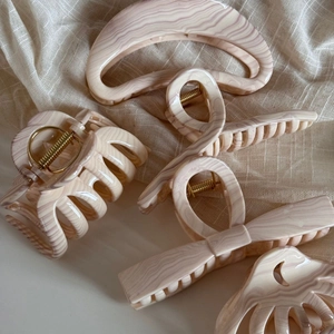 Five assorted marble pattern hair claws in elegant beige and lilac wavy textures