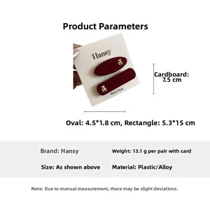 Detail view of burgundy hair clips set with gold bear charms and sizing specifications
