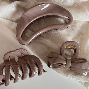 Detailed set of three dusty pink marble texture hair claw clips for elegant hair styling