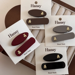Minimalist bear hair clip set in gold and resin colors including black, red, and grey