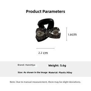 Detailed view of black bow hair claw clip with rhinestones measuring 2.2cm by 1.8cm