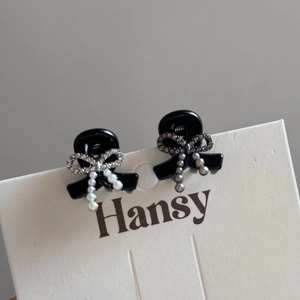 Elegant black bow hair clips with rhinestones and hanging pearls on display card