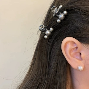 Elegant gray pearl hair clips with metallic base shown on a model for a minimalist hair look