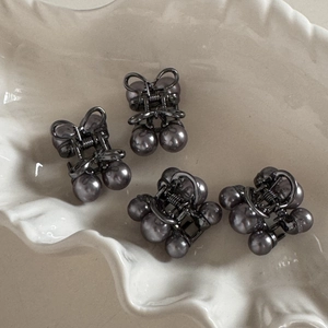 Set of four mini gunmetal hair clips with dark grey pearls and bow design details