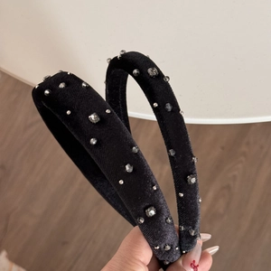 Detail of black velvet headband with sparkling rhinestones and silver beads on thick band