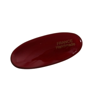 Minimalist oval dark red hair clip with golden France Handmade text on white background