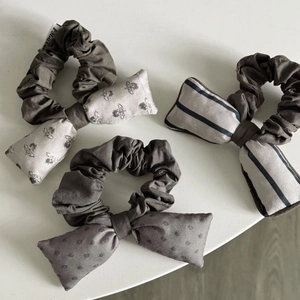 Detail view of retro double-layer scrunchies with bee, stripe, and polka dot patterns