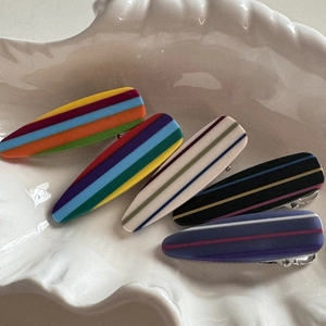 Five-piece colorful striped drop-shaped alligator hair clips set in a shell tray