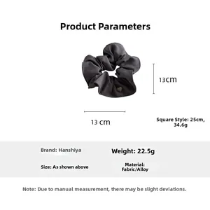Detailed view of dark grey scrunchie showing 13cm diameter and heart charm detail