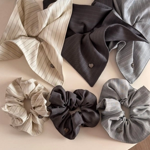 Striped scrunchies and matching scarves with heart pendants in beige and grey tones