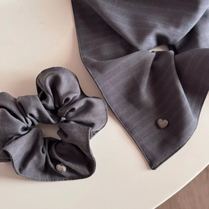Detail of grey satin scrunchie and scarf set with heart-shaped rhinestone embellishments