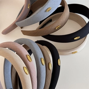 Wide fabric headband set in multiple colors with elegant gold metal accent and thick sponge pad