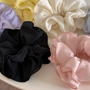 Elegant oversized ruffled scrunchies in pastel chiffon fabrics for various hairstyles