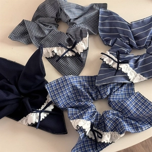 Detailed view of four blue plaid and striped scrunchies with delicate bow accents