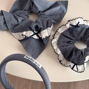 Close-up of blue plaid hair accessories set with bows and white ruffle edge details