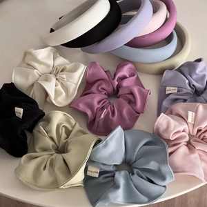 Close-up of assorted macaron colored sponge headbands and handmade fabric scrunchies