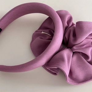 Detail of lilac purple sponge headband and matching fabric scrunchie set texture