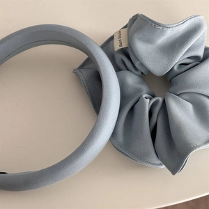 Close-up of sky blue sponge headband and matching hair scrunchie set with fabric texture