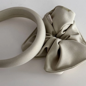 Detail of beige sponge headband and matching scrunchie with Hand Made woven label