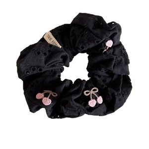 Black hollow-out fabric scrunchie with pink cherry embroidery and cream label
