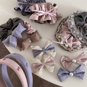 Detail of Morandi-toned hair accessories set with lace, pearls, and satin textures