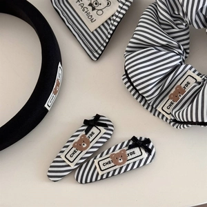 Black and white striped hair accessory set including headband and scrunchie with bear label
