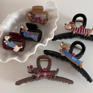 Cute cartoon dachshund hair claws set in various colors on a white ceramic tray