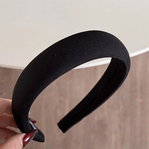 Detailed view of the thick black sponge headband with vertical fabric texture and padding