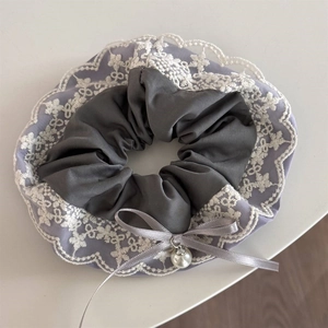 Detail of grey satin hair scrunchie with lavender mesh, white lace and pearl bow charm