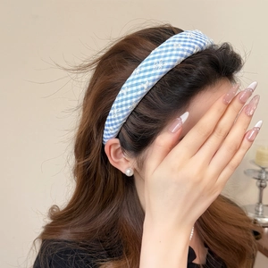Blue and white plaid headband with white snowflake embroidery for a stylish hair look