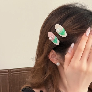 Floral embossed pearl acetate hair clips in pink and white jelly colors worn by model