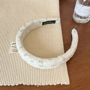 Detail of floral embroidery on wide light blue headband with non-slip inner strap