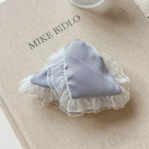 Detail of light blue satin hair clips with delicate white lace trim and elegant ruffles