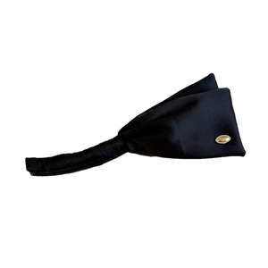 Elegant black satin banana hair clip with a stylish oval gold metal emblem for women