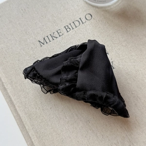 Close-up of elegant black satin hair claw clip with delicate mesh lace edging details