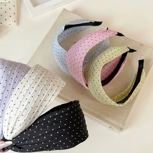 Detailed view of colorful polka dot pleated headbands with non-slip inner teeth