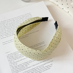 Detailed view of candy color polka dot headband with pleated fabric texture and non-slip teeth