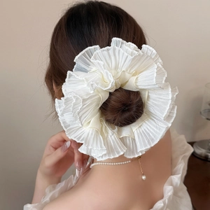 Elegant white ruffled oversized scrunchie made of chiffon for a high-end hairstyle look