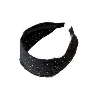 Classic black fabric headband with white polka dots and non-slip inner teeth for women