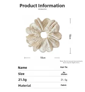 Detail showing the 18cm diameter of the beige lace hair scrunchie with pearl accents
