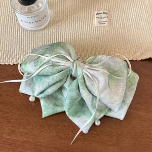 Pince à cheveux satinée motif marbre vert avec nœud en ruban et perles élégantes