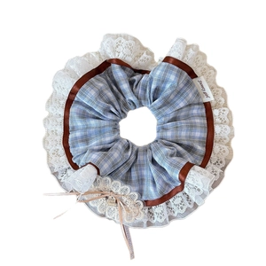 Ballet style plaid scrunchie with lace edge and Good Luck pendant on white background