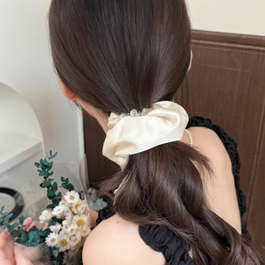 Elegant cream satin scrunchie with crystal beads and gold chains for ponytail styling