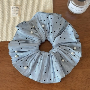 Detail of light blue polka dot scrunchie with pearls and soft pleated texture