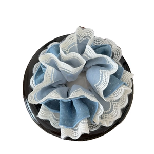 Sky blue chiffon hair scrunchie with elegant white floral lace edges for bun styling