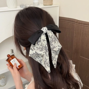Elegant black and floral print ribbon bow hair claw clip for a French vintage hairstyle