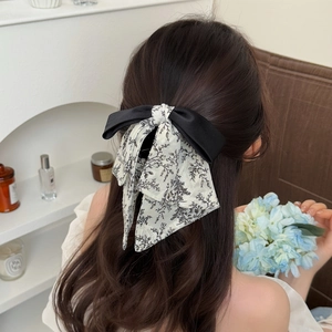 Floral print bow hair claw clip for women with elegant black and white fabric finish